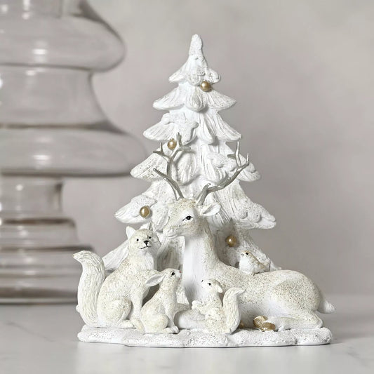 White ceramic deer, rabbit and squirrel figurine with a Christmas tree with gold balls