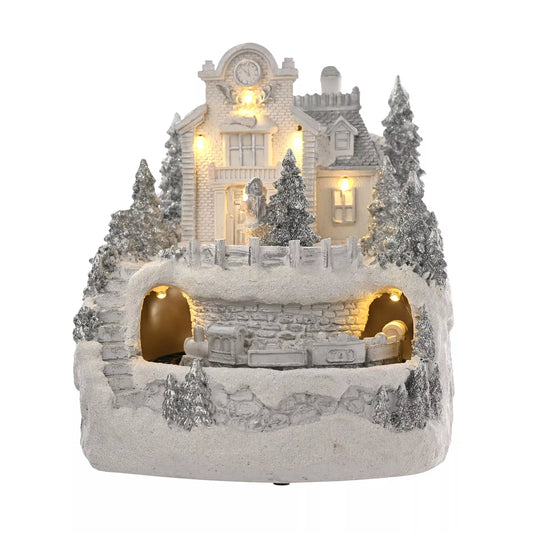 Decorative snow-covered led christmas house with lights and moving train