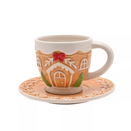 Gingerbread house-themed mug and saucer set with red bow