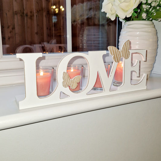 cream washed wood and glass 'Love' candle holder. with natural wood sinish butterfly details and glass cups for 4 tea-light candles.