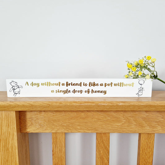 crisp white 40cm plaque features delicate pencil style Winnie The Pooh illustrations and luxurious gold foiled writing